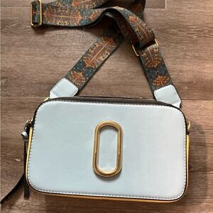 White Crossbody Camera Bag with Gold Accent and Patterned Strap